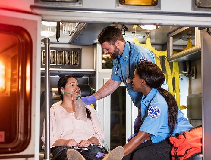 EMTs treating a patient inside an ambulance