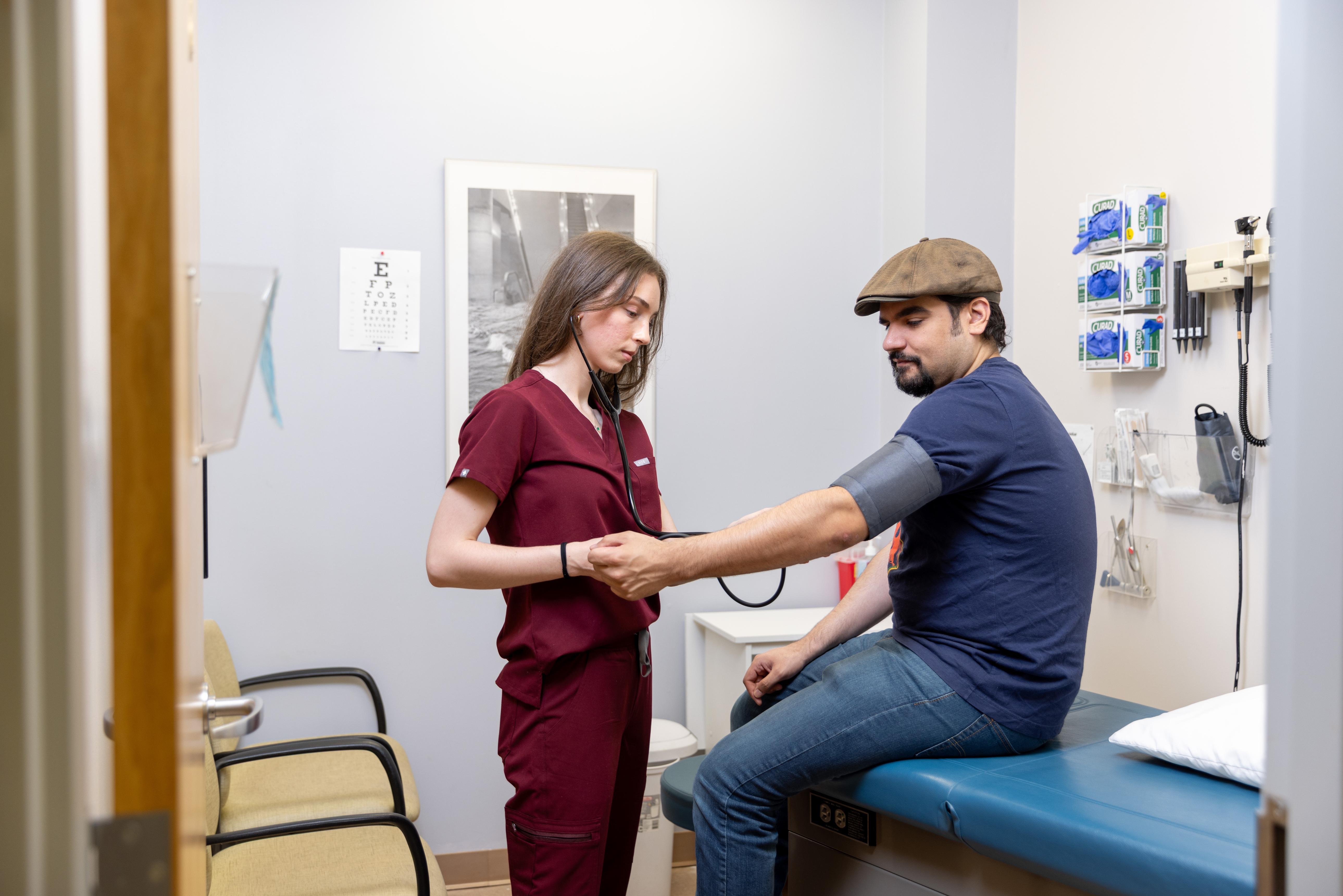 A medical assistant taking a patient's blood pressure